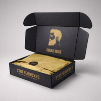 Black 'Chad Box' packaging with gold interior and 'StuffedBoxes' branding on a gray background