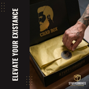 Hand opening a 'Chad Box' with gold interior and 'Stuffed Boxes' branding. "Elevate Your Existance"